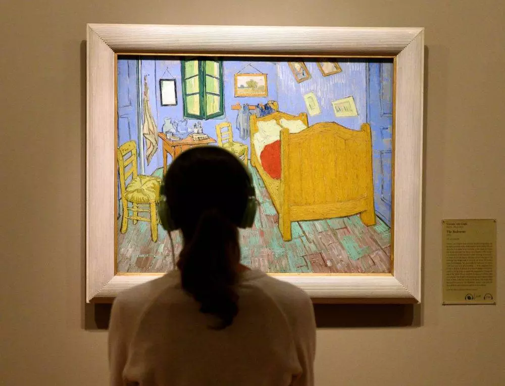  Woman look at the The Bedroom by Vincent van Gogh painting in Art Institute of Chicago.
