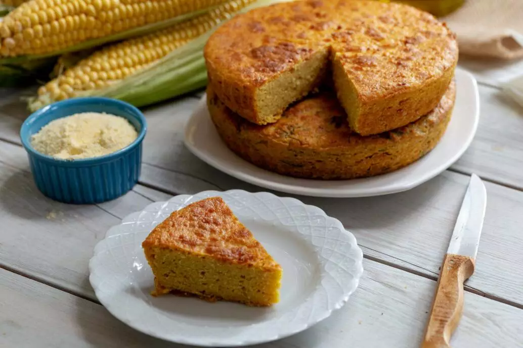 Fresh baked corn bread on wooden background