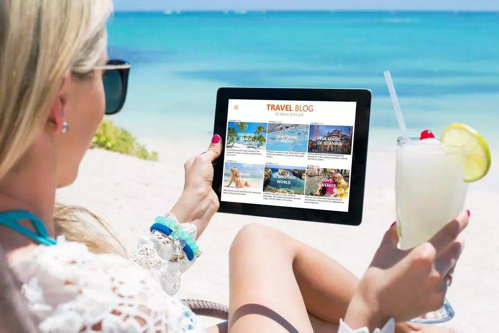 Woman reading travel blog on tablet.